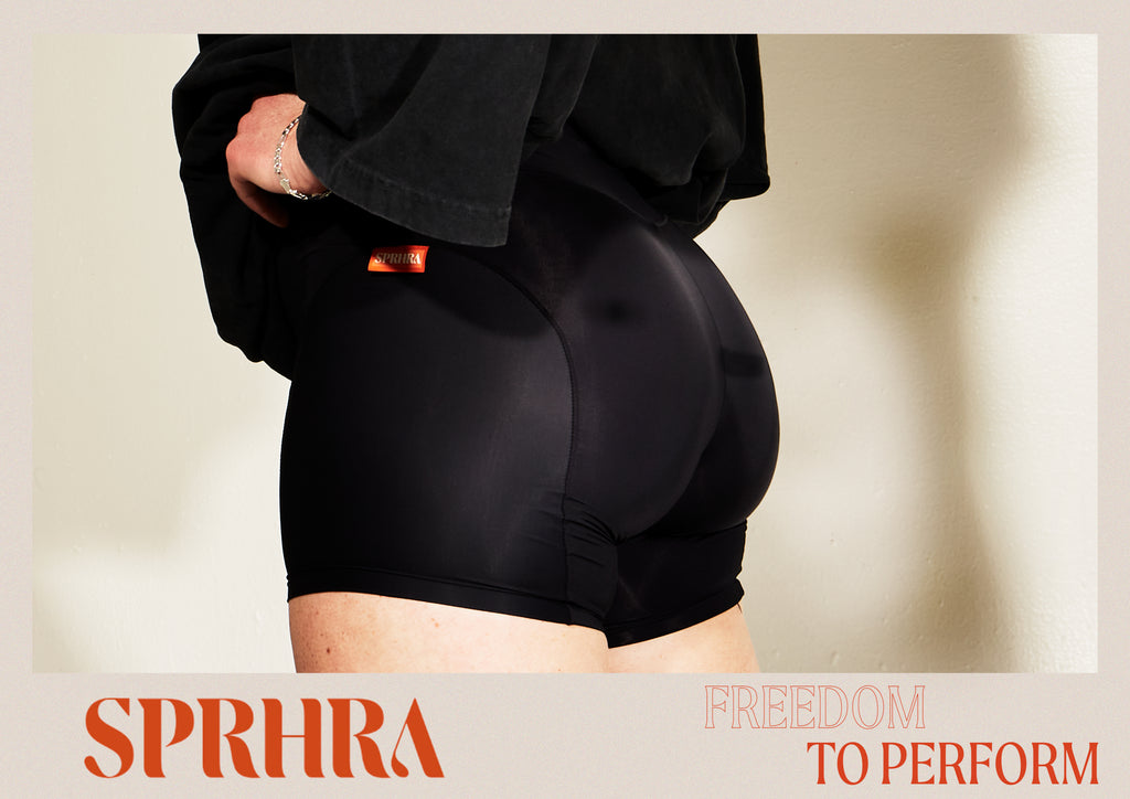 Female athlete facing the right in a baggy, oversized black t-shirt, wearing the SPRHRA Jump Wrap Spandex in Abyss